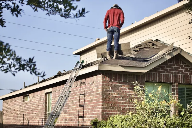 Professional roofer working on a residential roof in Rincon